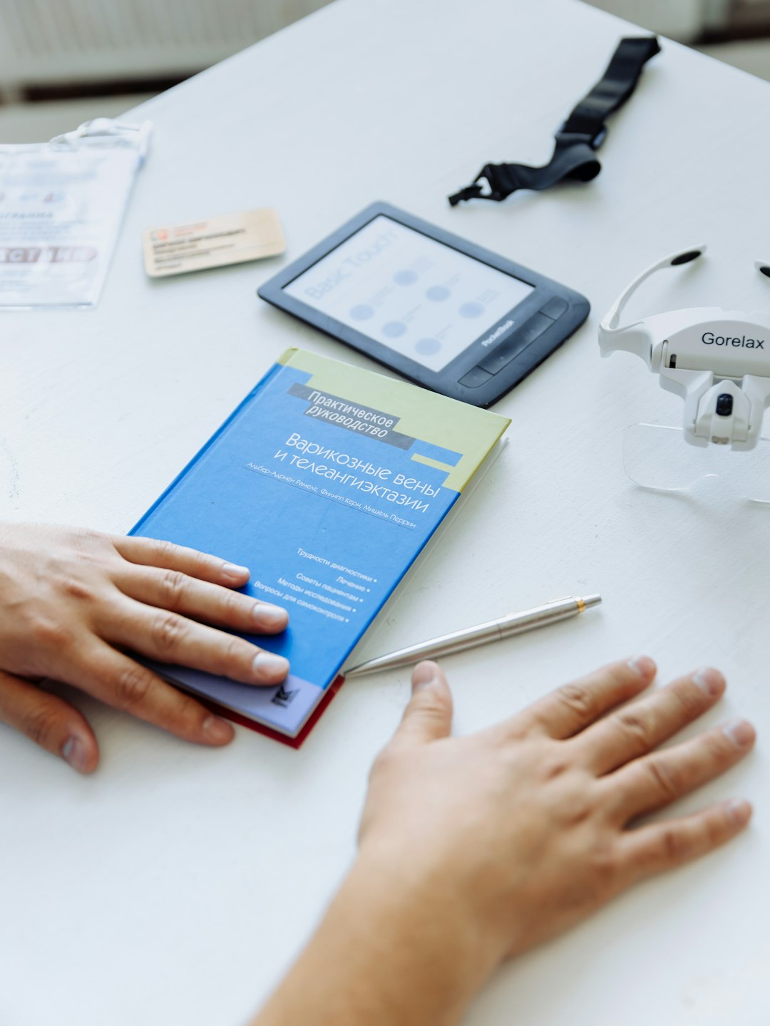 a-person-holding-a-book-near-a-remote-control-dydvm6bakxg